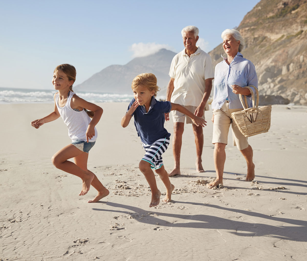 seniors with their grandkids on the beach