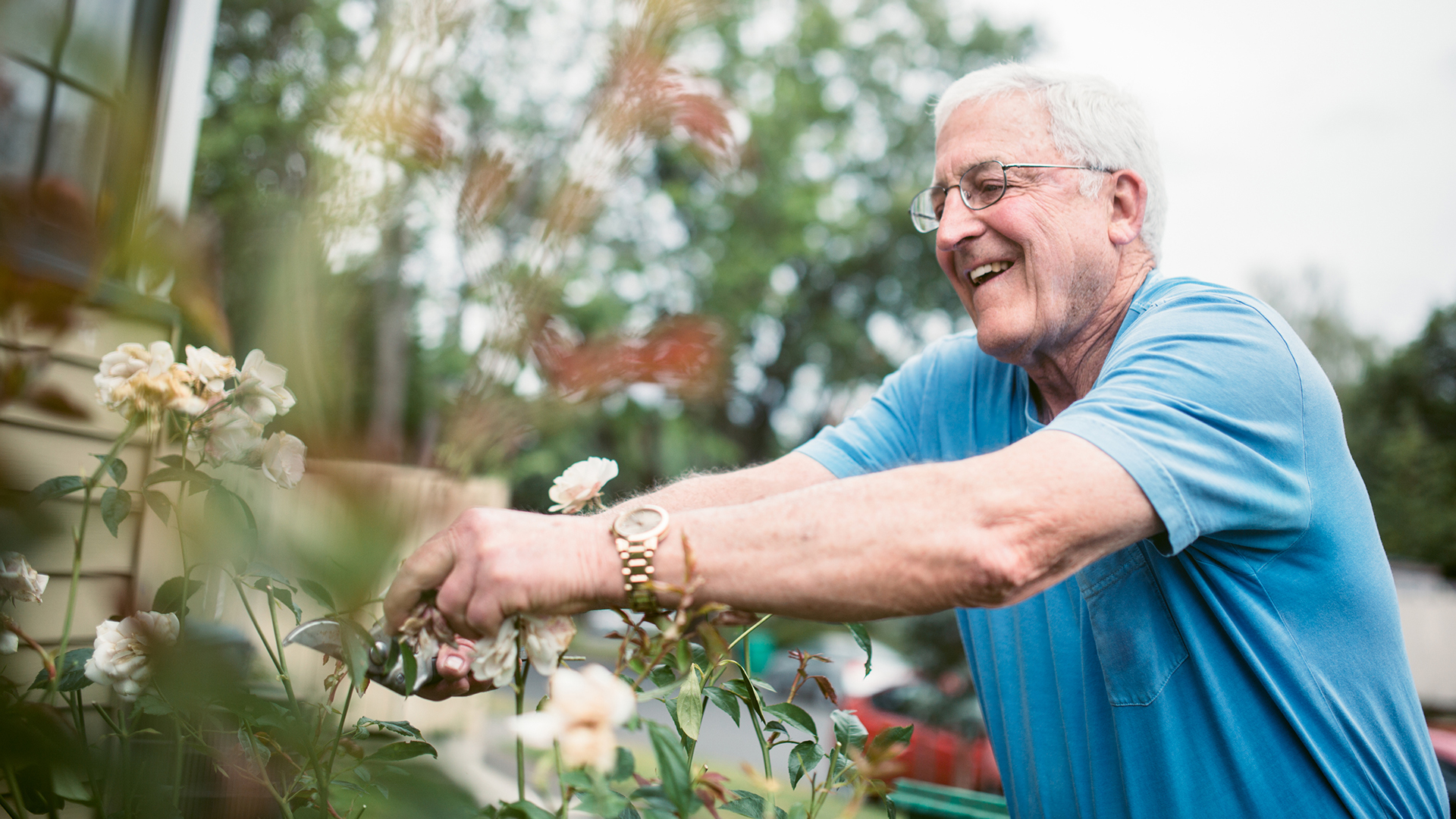 senior man tending to his garden outside